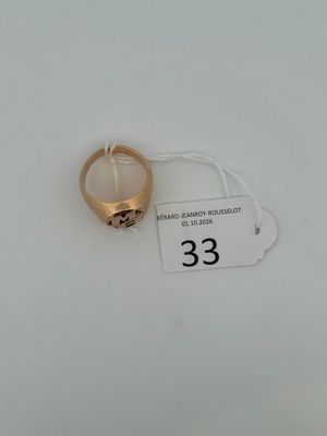 an image of a gold ring on a white surface with a price tag