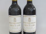 two bottles of wine sitting next to each other on a table
