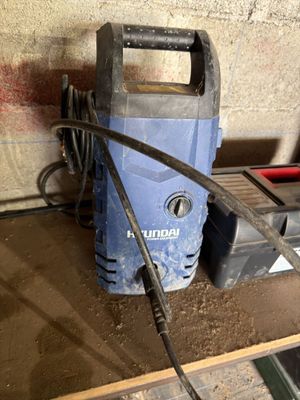 a blue and black power drill sitting on a table