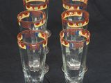 four glasses with a design on them on a black background