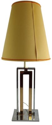 a lamp that is on a table with a lamp shade on it