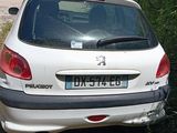 a small white car that is parked on the side of the road