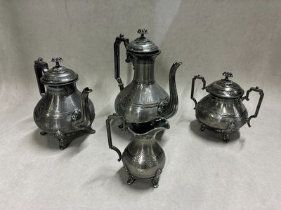 four pieces of silver tea and coffee set on a white background