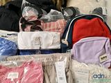 many bags of clothes and bags of clothing on the floor