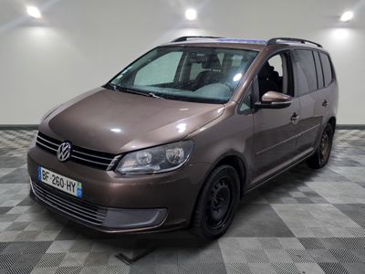 the brown van is parked on a checkered floor in the garage