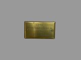 the name plate of a brass plaque on a gray wall