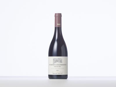 a bottle of red wine sitting on top of a table