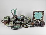many pieces of pottery that are sitting on a table