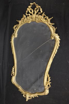 an antique gold framed mirror on a black background