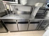 a stainless steel counter top in a commercial kitchen