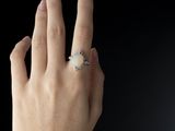 a woman ' s hand with a ring on it ' s finger
