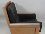 the chair is made of leather and has a wooden frame