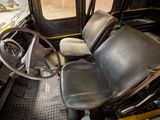 a black and yellow bus with a steering wheel