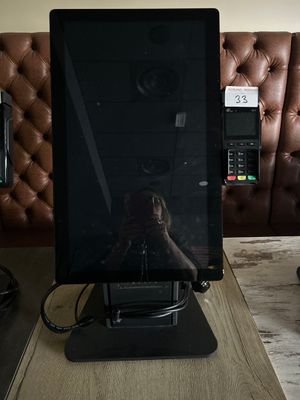 a laptop computer sitting on top of a wooden table