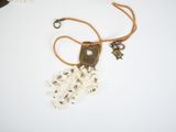 a necklace that has a bunch of small white flowers on it