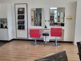 an image of a hair salon with chairs and a counter
