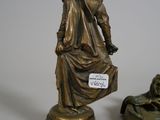 two bronze figurines of a woman and a dog