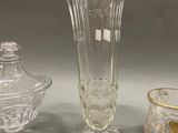 three glass vases and a sugar dish are sitting on a table