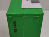 a close up of the back of a green box on a white surface
