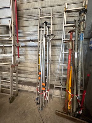 many different types of baseball bats in a garage