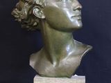 sculpture of a woman ' s head on a marble base