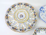 three decorative plates are sitting on a table with a white background