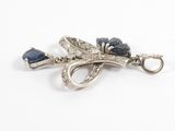 an image of a close up of a blue and white diamond broochle