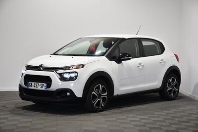a white citrole is parked in a room with a checkered floor