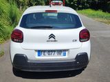 a white car that is parked on the side of the road