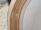 a close up of a chair with a wooden frame