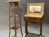 a small desk with a mirror on it next to a shelf