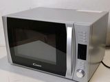 an image of a silver microwave oven on a table