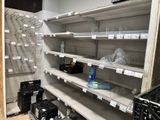 many empty shelves in a store with many items on them