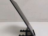 the back of a tablet computer sitting on top of a white table