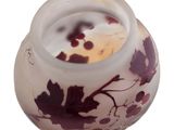 a small vase with a red and white design on it