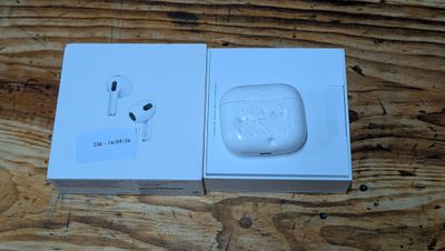 an apple airpods in a box on a wooden table