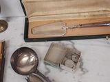 a lot of silver spoons and spoons on the table