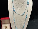 a group of jewelry including a necklace, bracelet, and ring