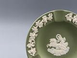 a green plate with a picture of a man on a horse on it