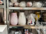 a shelf full of vases and other items in a room