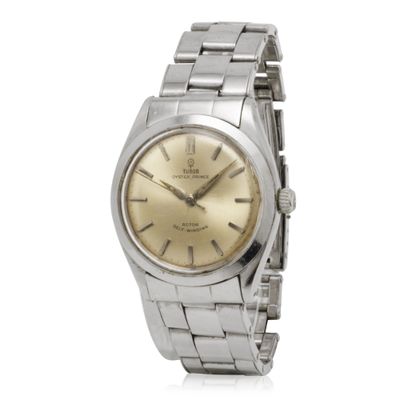 a close up of a watch on a white surface with a white background