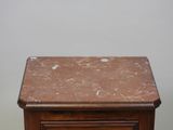 a marble top table with a drawer underneath it