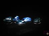 a group of blue and white diamonds on a black surface