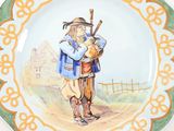 a plate with a picture of a man playing a bagpipe