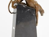 bronze sculpture of a cat on a black marble block