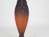 a blue and orange vase sitting on a white surface