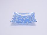 rectangular blue and white glass dish with white swirl design