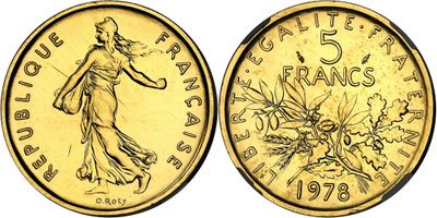 a close up of a gold coin with a woman on it