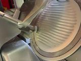 an image of a commercial meat slicer in a kitchen