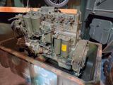 an old military engine sitting in the back of a truck